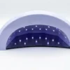 Na bijeloj pozadini postavljena ProStudio uv/led lampa brenda Nailuxe, uslikana sa prednje strane kako bi se videle diode